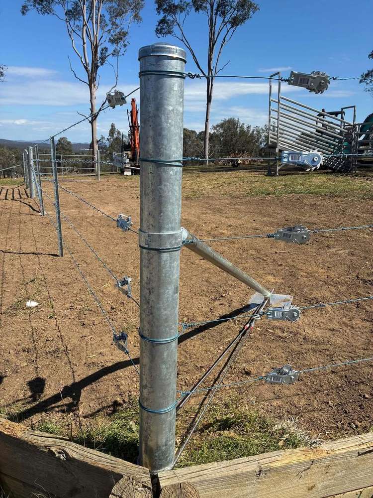 Galvanised steel strainer post with stay and tensioned barbed and plain wire